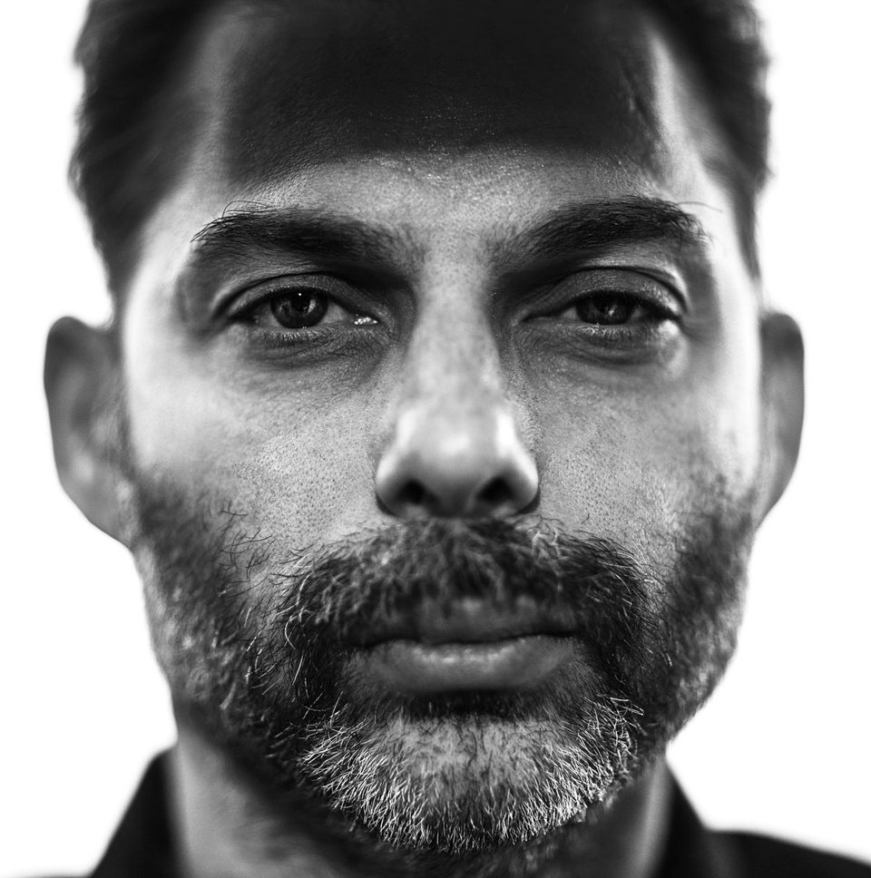 Tight black-and-white close-up of Payman Maadi's face