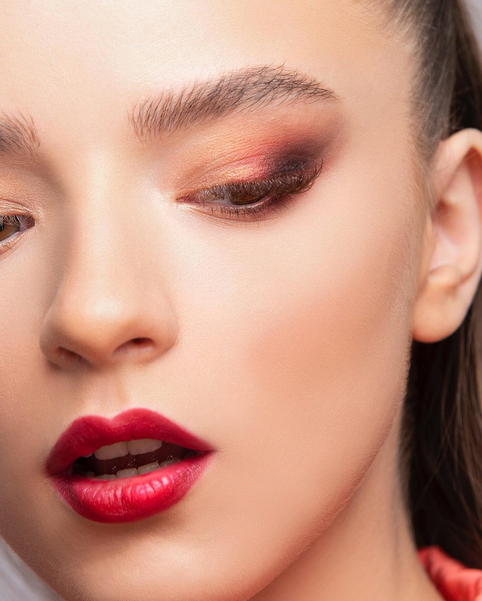 Close beauty portrait with copper eyeshadow and red lips