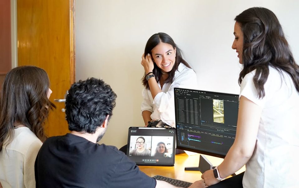 Studio members review a video edit with colleagues on a video call