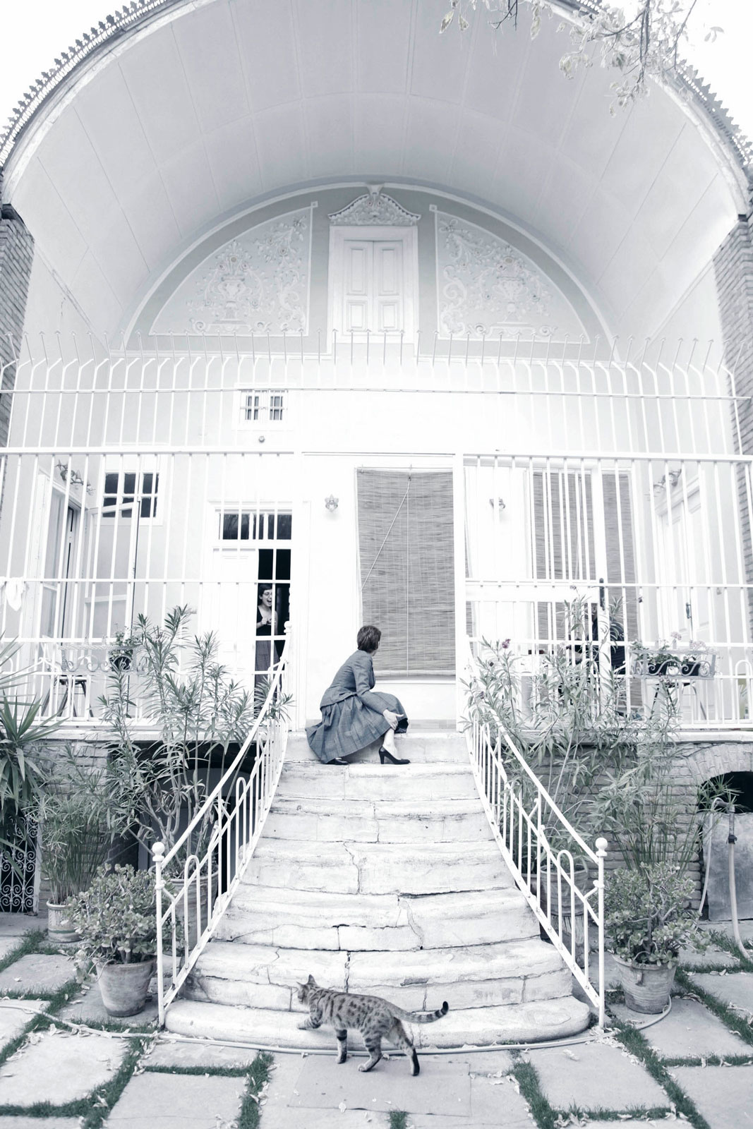 Mirrors & Women – Smoke, Tehran, Iran (2016) Black and white portrait of a woman smoking beside a window, surrounded by soft reflections. From Reihane Taravati’s “Mirrors & Women” series, Tehran, 2016.